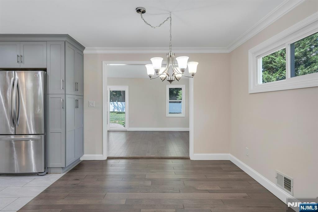 82 Little Falls Road Cedar Grove, NJ 07009 - Photo 11 of 36 a view of a livingroom with a chandelier wooden floor and a chandelier