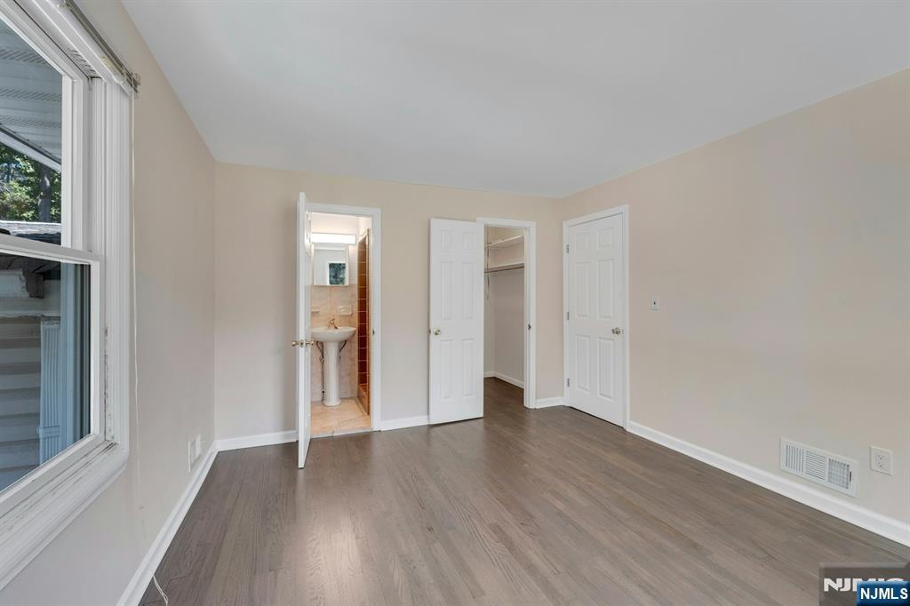 82 Little Falls Road Cedar Grove, NJ 07009 - Photo 17 of 36 a big room with wooden floor and windows