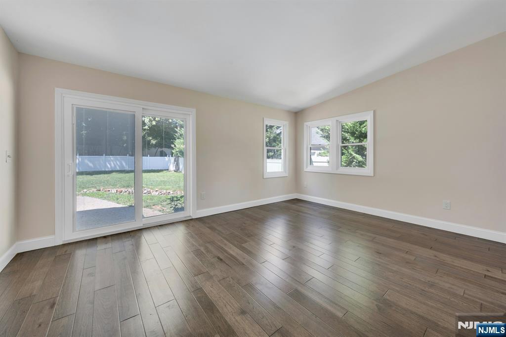 82 Little Falls Road Cedar Grove, NJ 07009 - Photo 20 of 36 a view of an empty room with wooden floor and a window