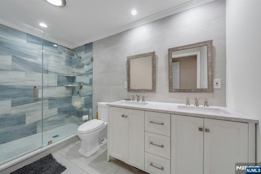 82 Little Falls Road Cedar Grove, NJ 07009 - Photo 22 of 36 a bathroom with a double vanity sink toilet and shower