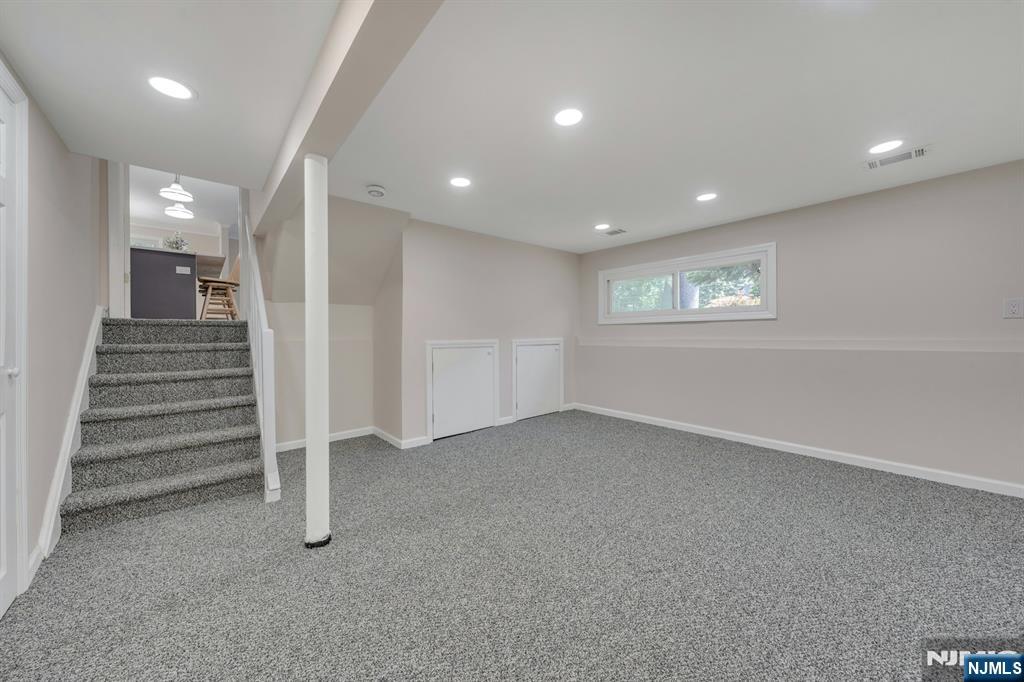 82 Little Falls Road Cedar Grove, NJ 07009 - Photo 25 of 36 an empty room with a entryway and stairs