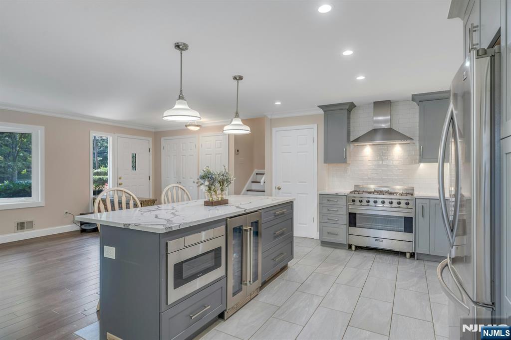 82 Little Falls Road Cedar Grove, NJ 07009 - Photo 3 of 36 a kitchen with kitchen island a sink stove and wooden floor