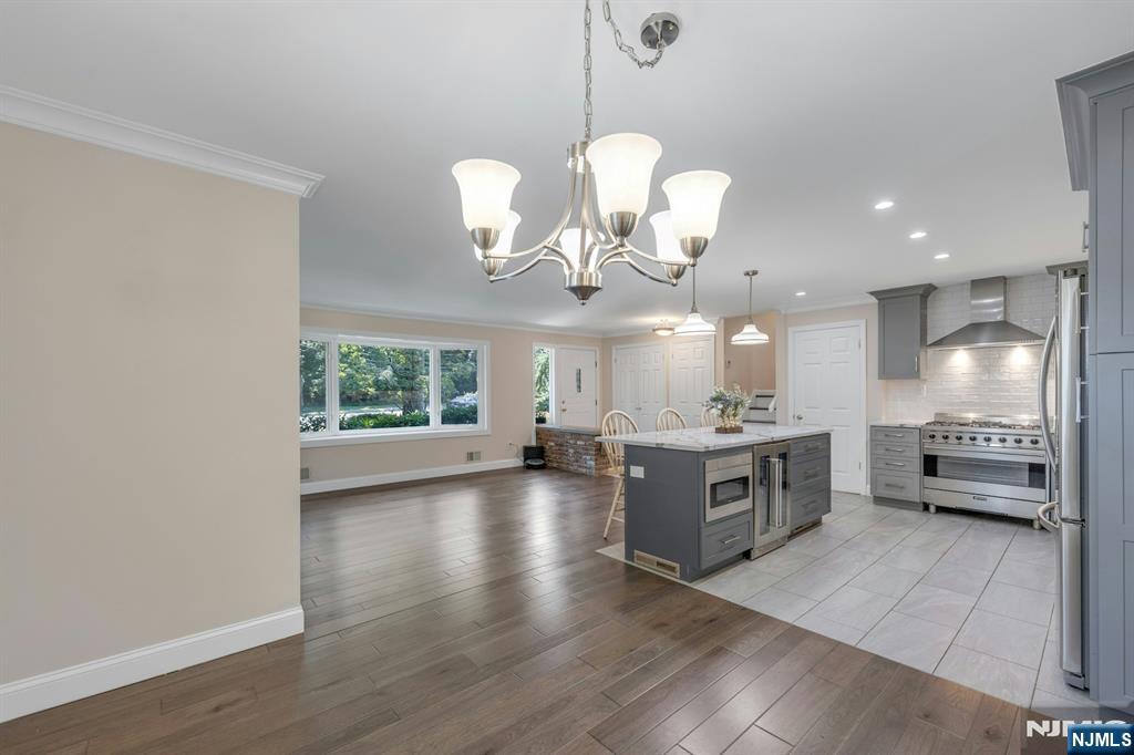 82 Little Falls Road Cedar Grove, NJ 07009 - Photo 9 of 36 a large kitchen with a large window a sink stainless steel appliances and cabinets