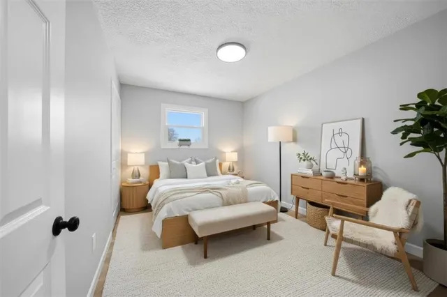 a spacious bedroom with a bed and a couch