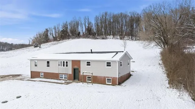 a view of a house with snow in the background