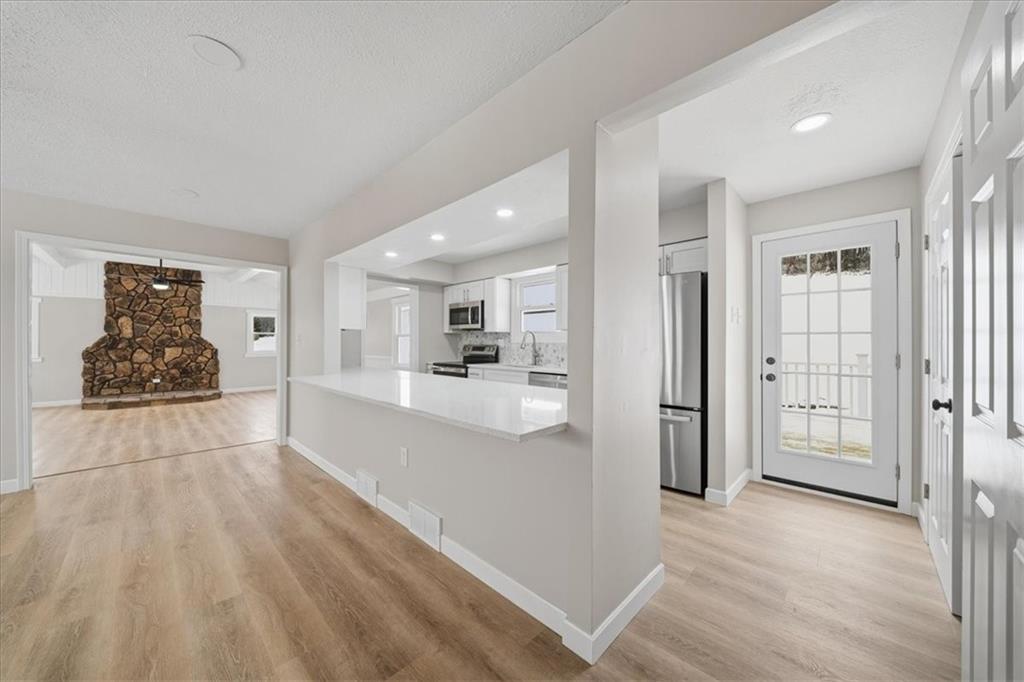214 McCleary Road Aliquippa, PA 15001 - Photo 5 of 29 a view of a kitchen with refrigerator and wooden floor