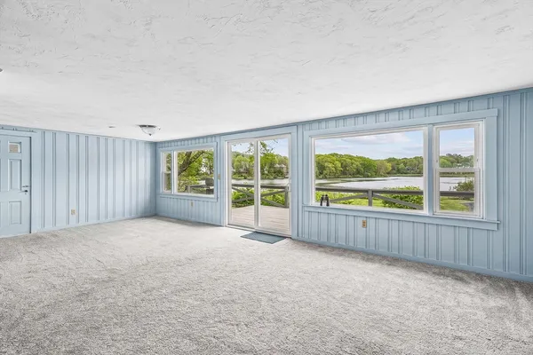 an empty room with large windows