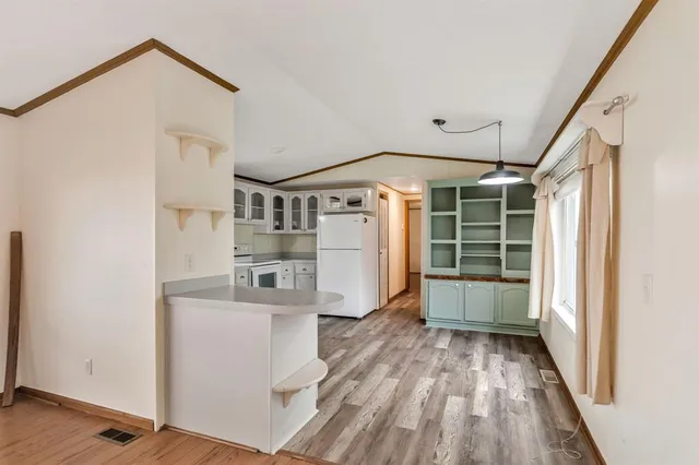 a view of a storage and utility room with wooden floor