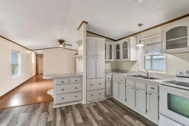 a spacious bathroom with a granite countertop sink and a mirror