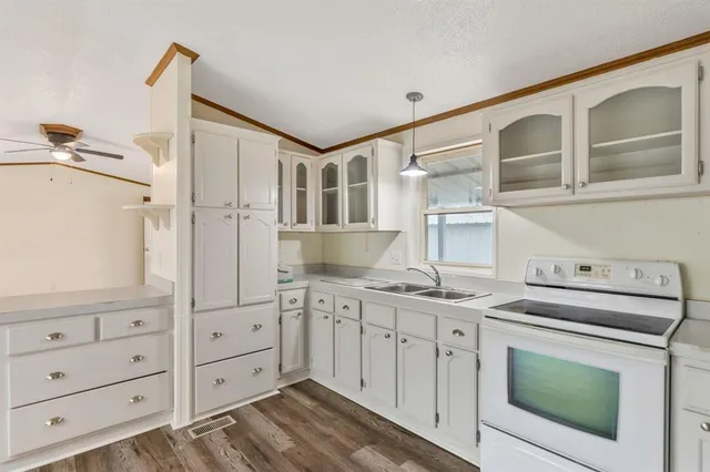 a kitchen with cabinets appliances and a counter space