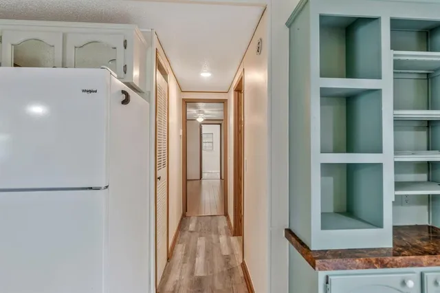 a view of a hallway with wooden floor