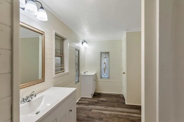 a spacious bathroom with a shower sink and a mirror