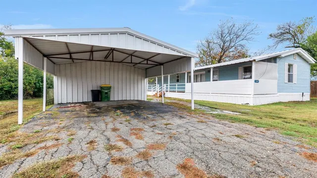 a view of a house with backyard and balcony