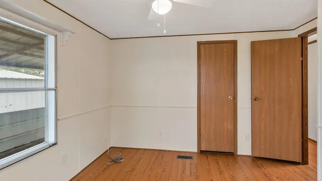 a view of a room with wooden floor