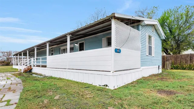 a view of house with backyard