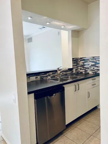 a kitchen with a sink and cabinets