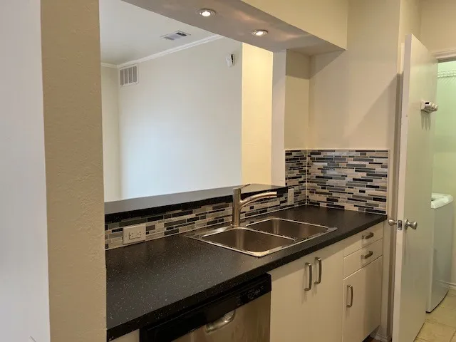 a kitchen that has a sink and a stove