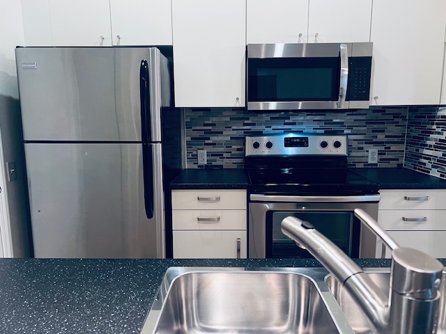 802 South 1st Street, Unit 117 Austin, TX 78704 - Photo 9 of 31 a kitchen with stainless steel appliances a refrigerator a stove a microwave and cabinets