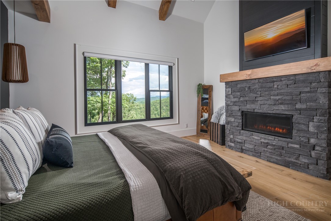 1236 Ninebark Road Boone, NC 28607 - Photo 18 of 50 a bed sitting in a bedroom next to a window