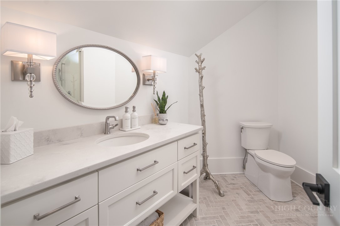 1236 Ninebark Road Boone, NC 28607 - Photo 25 of 50 a bathroom with a toilet sink and mirror