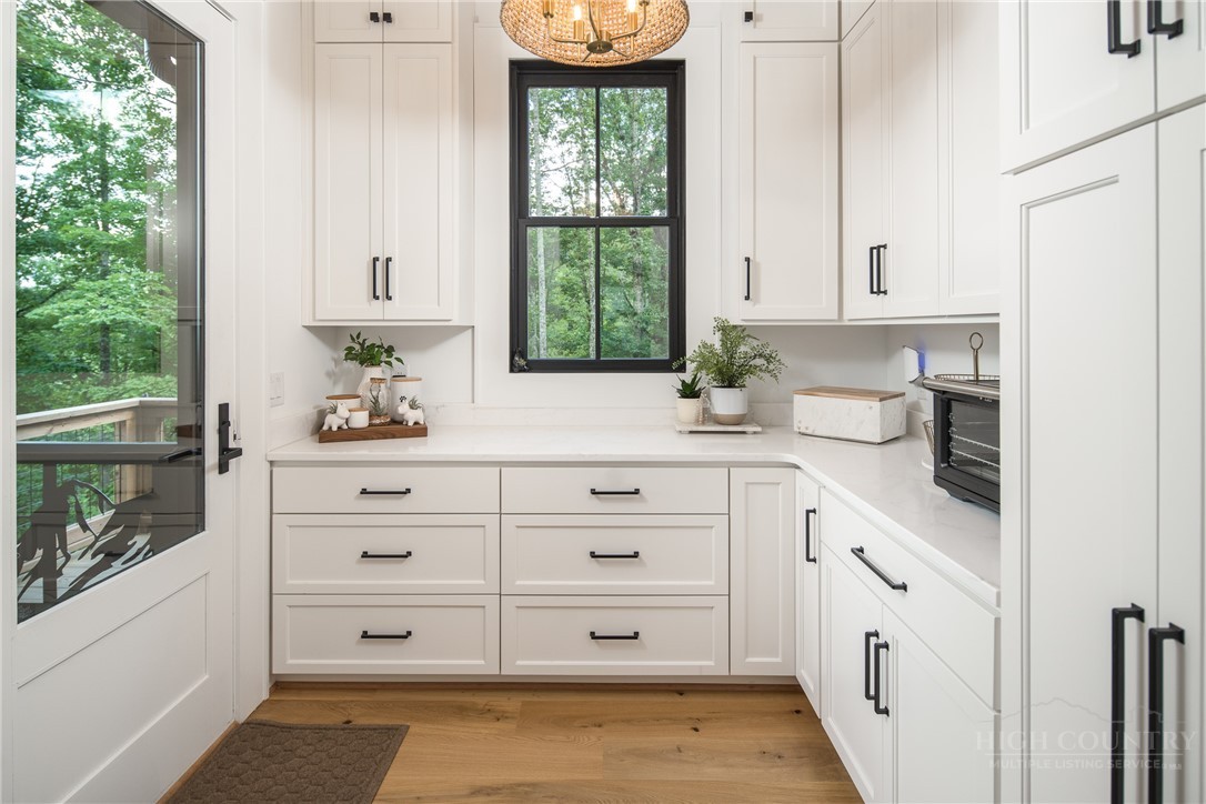 1236 Ninebark Road Boone, NC 28607 - Photo 10 of 50 a kitchen with white cabinets and window