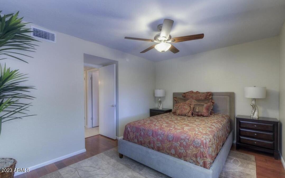 6609 East Phelps Road Scottsdale, AZ 85254 - Photo 20 of 83 a bedroom with a large bed and a chandelier