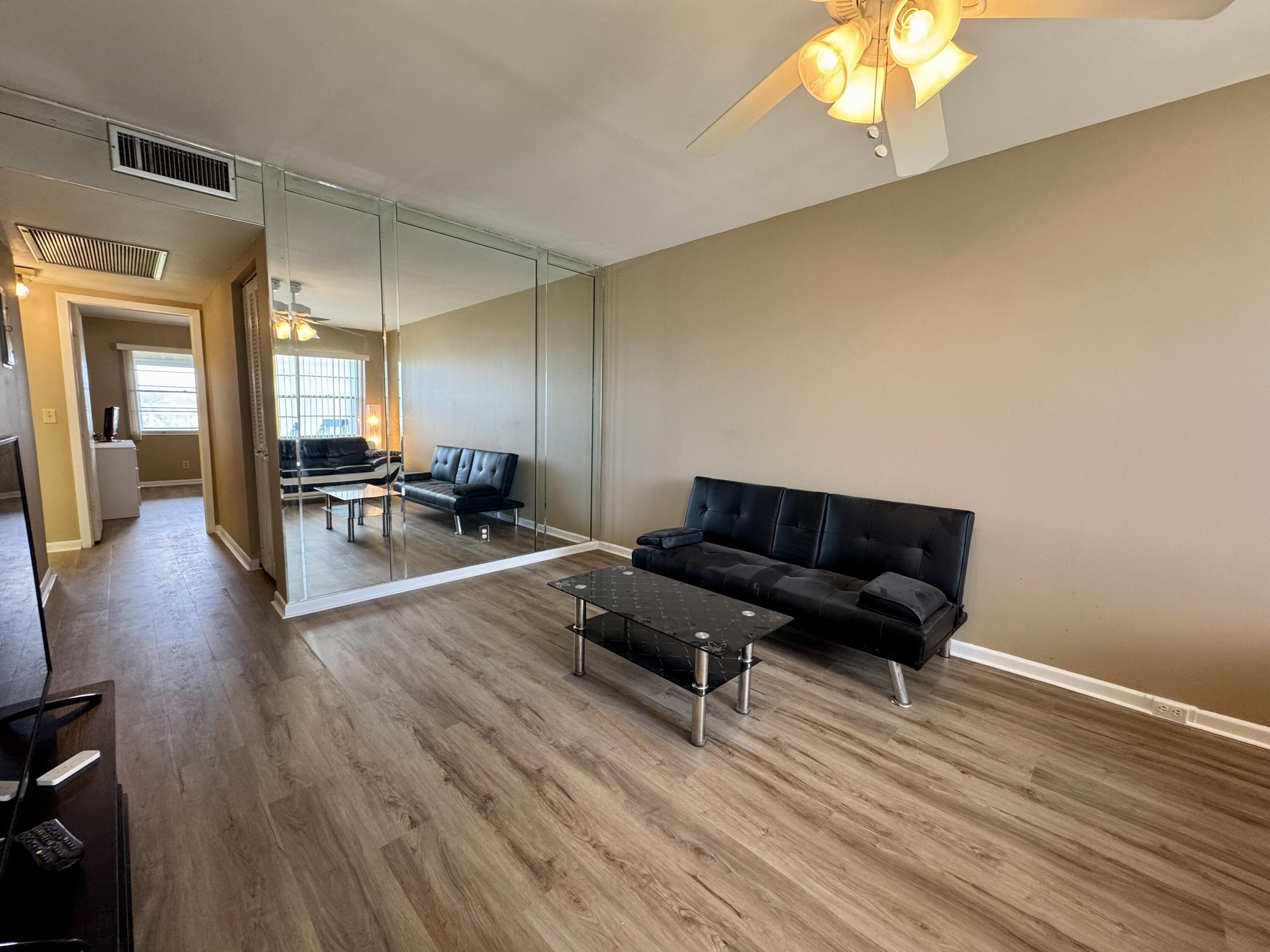 4019 Lincoln A Boca Raton, FL 33434 - Photo 11 of 36 a living room with furniture and a wooden floor