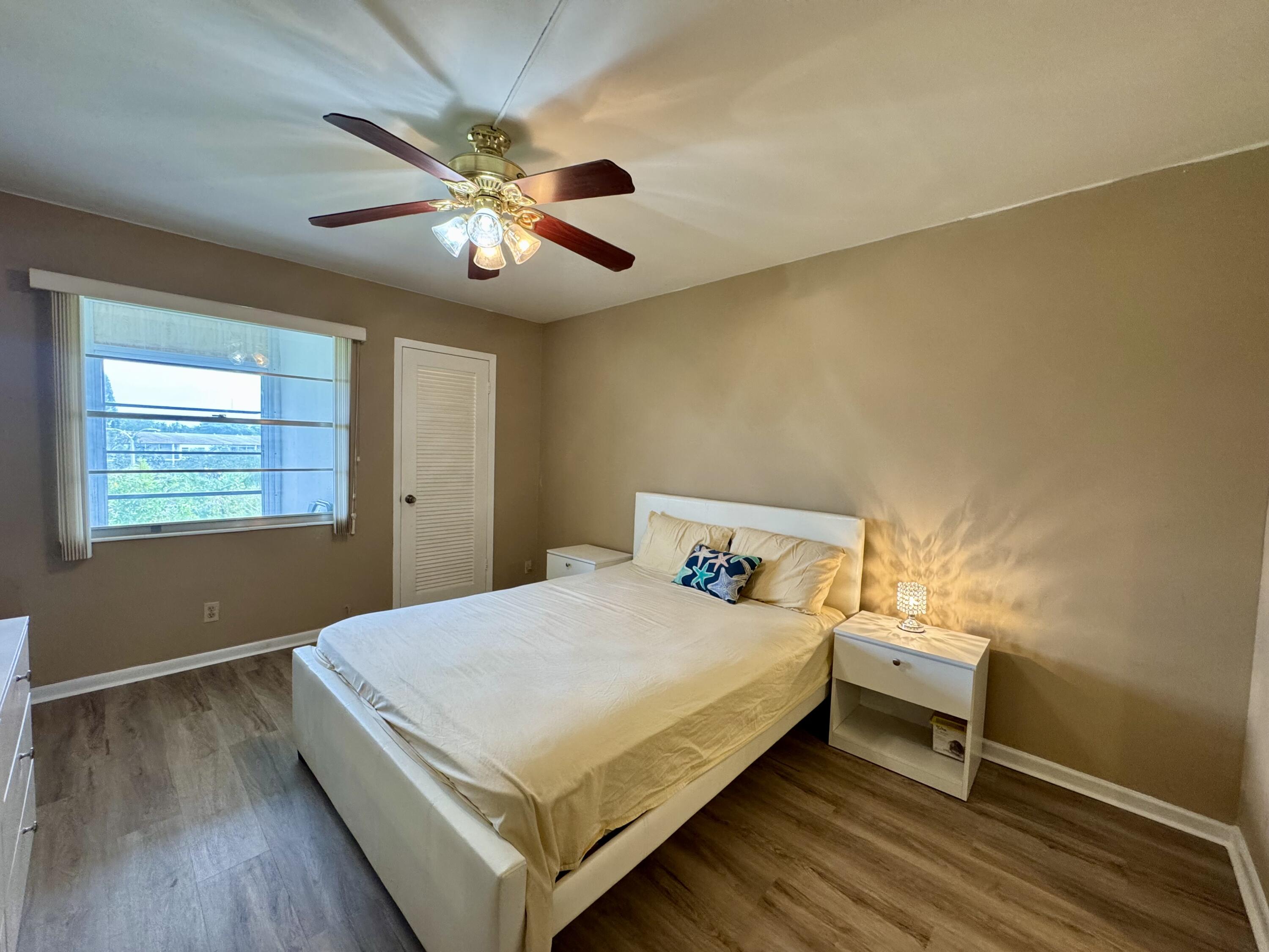 4019 Lincoln A Boca Raton, FL 33434 - Photo 12 of 36 a bedroom with a bed and a chandelier