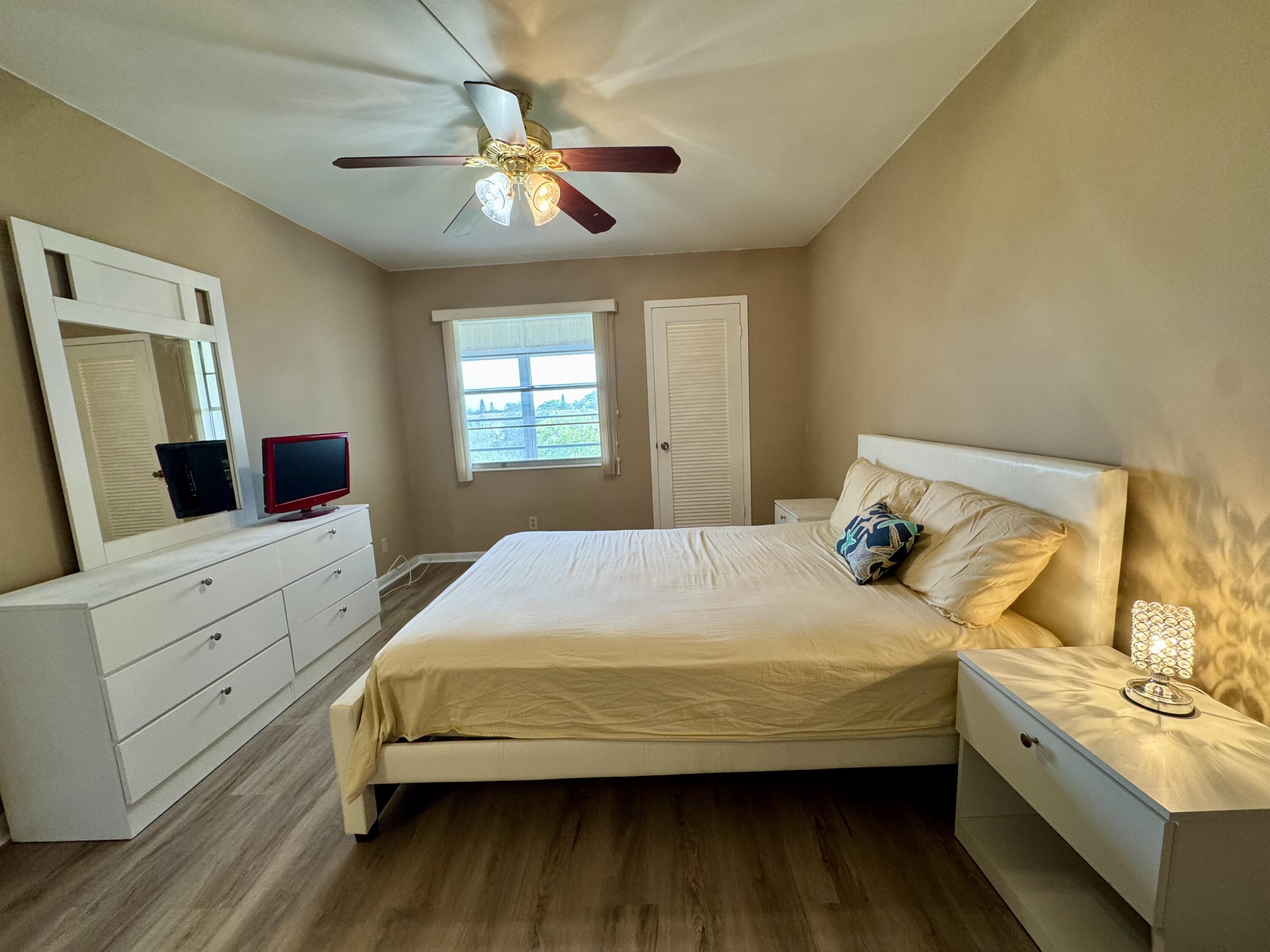 4019 Lincoln A Boca Raton, FL 33434 - Photo 16 of 36 a bedroom with a bed and a dresser