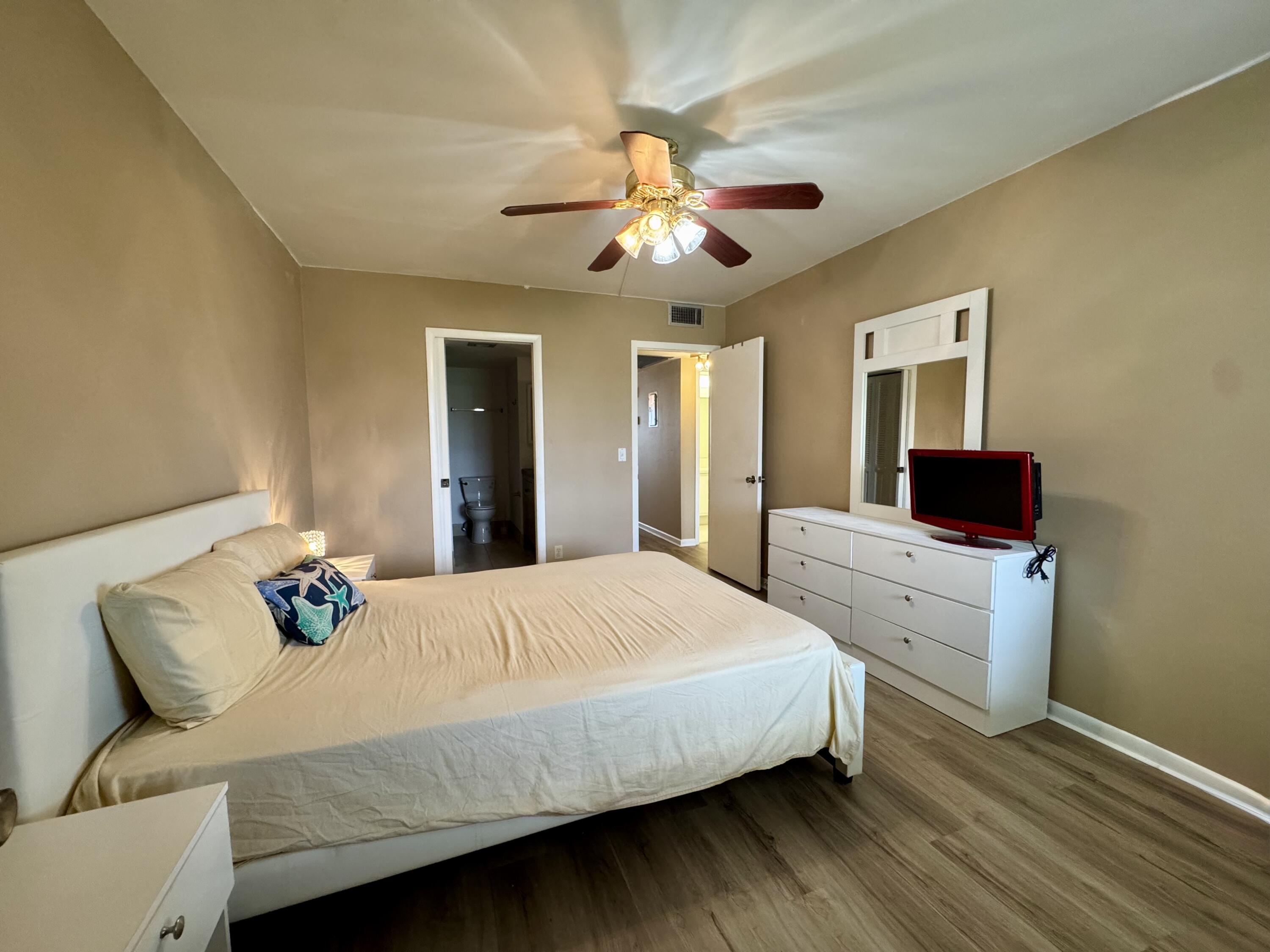 4019 Lincoln A Boca Raton, FL 33434 - Photo 18 of 36 a bedroom with a bed and wooden floor