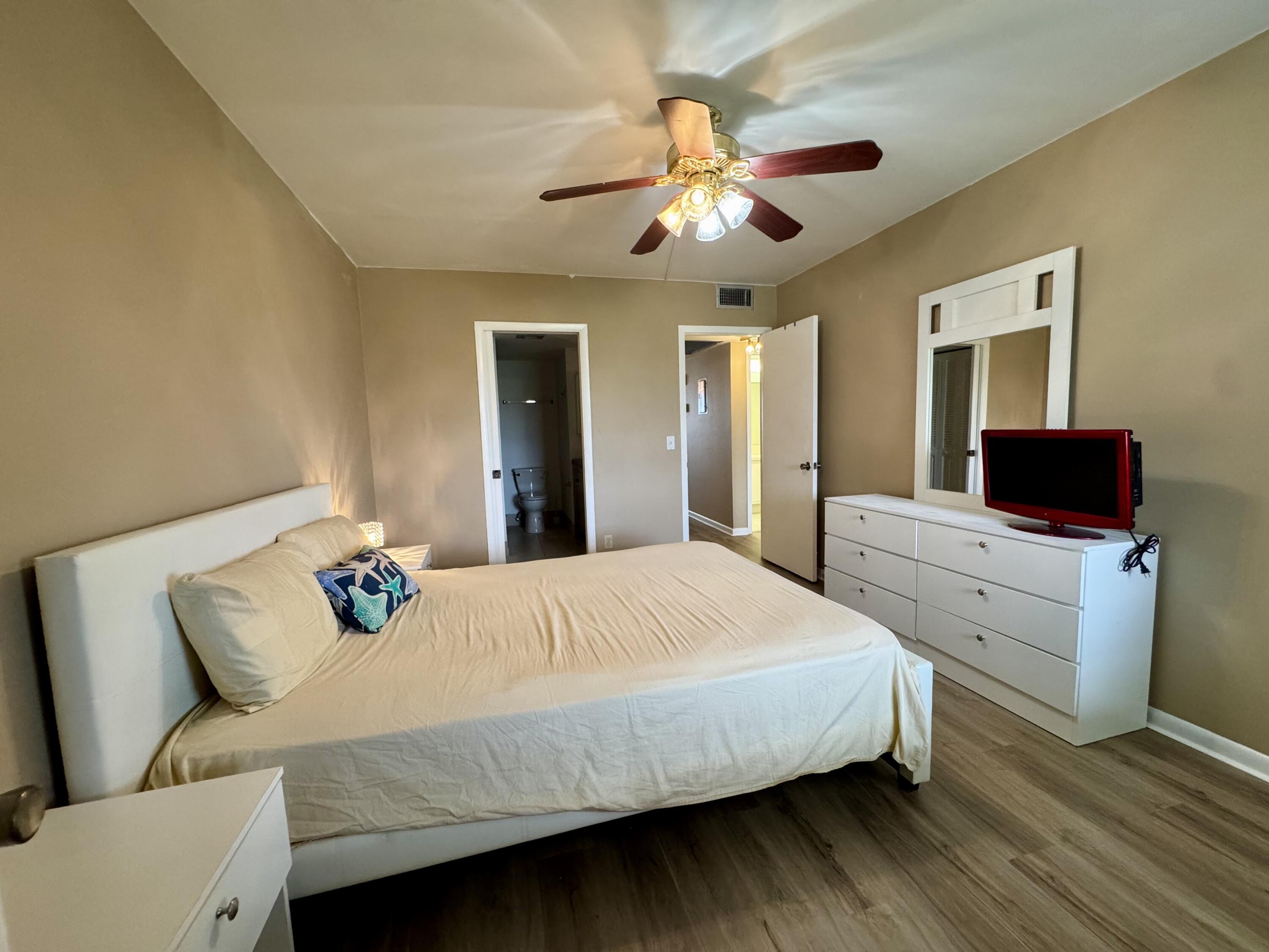 4019 Lincoln A Boca Raton, FL 33434 - Photo 19 of 36 a bedroom with a bed and a chandelier