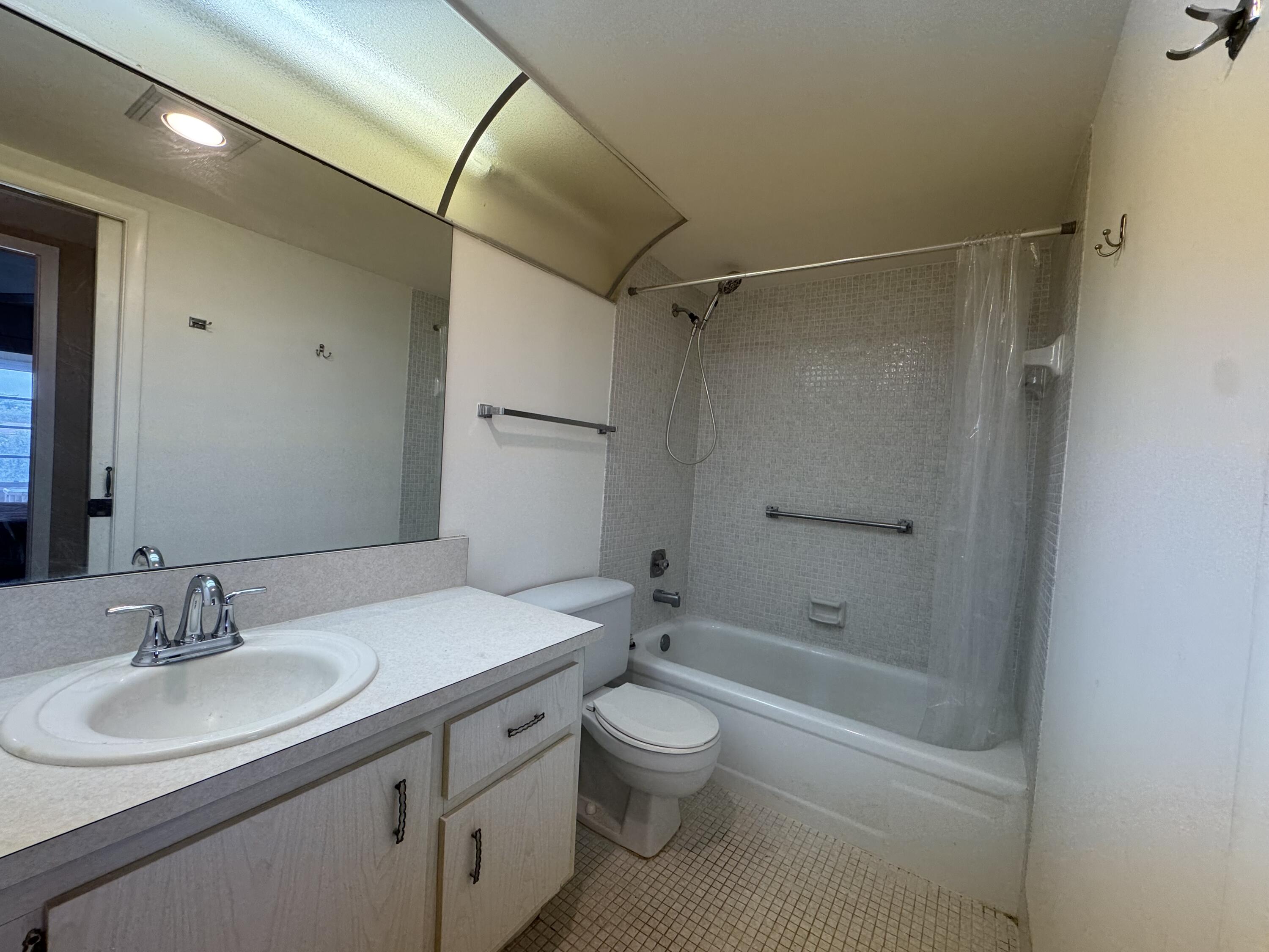 4019 Lincoln A Boca Raton, FL 33434 - Photo 20 of 36 a bathroom with a sink toilet and shower