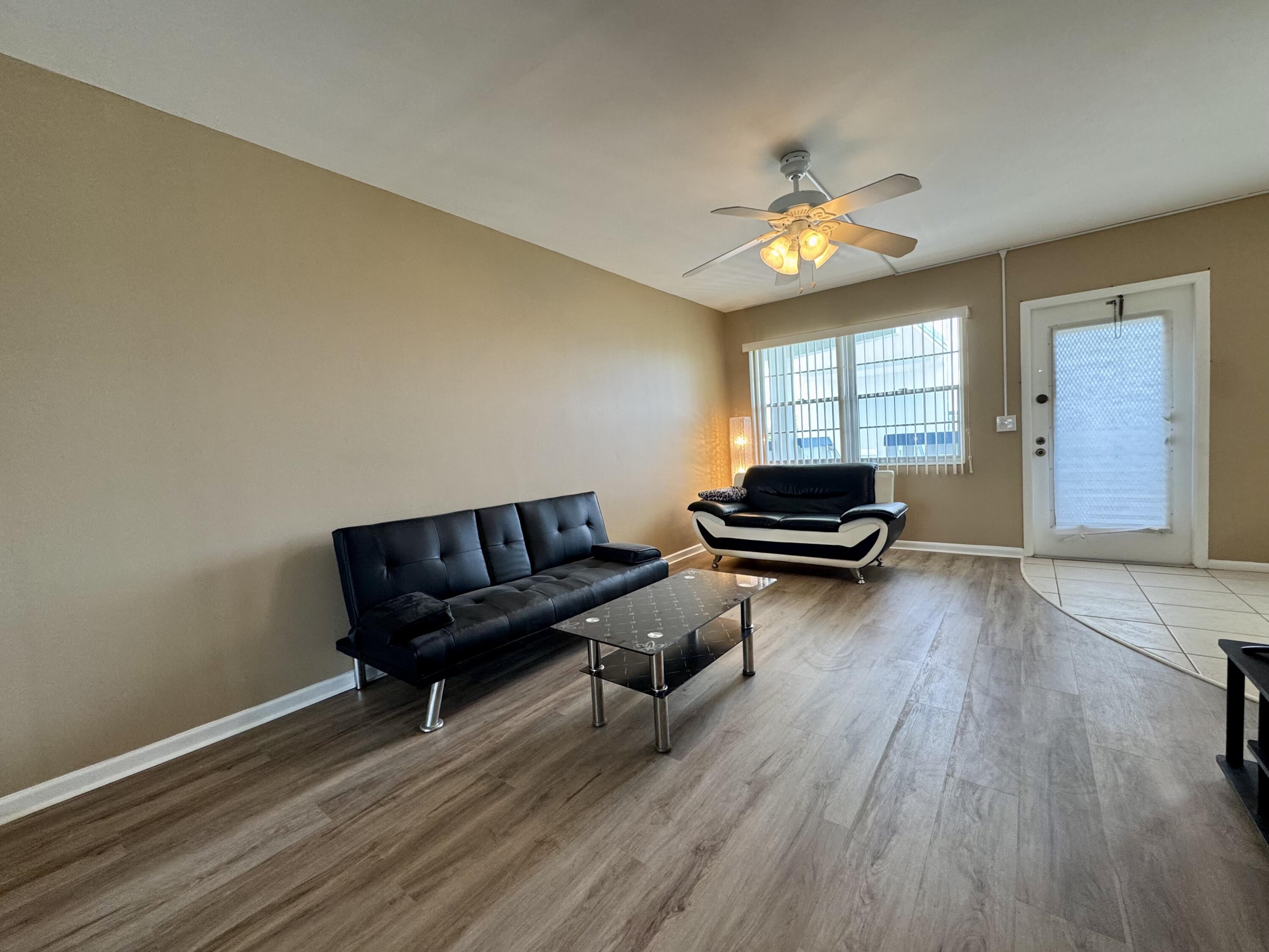 4019 Lincoln A Boca Raton, FL 33434 - Photo 28 of 36 a living room with furniture and a wooden floor
