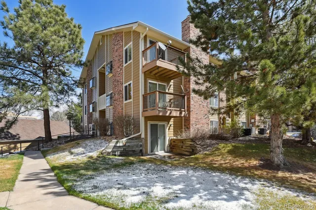 a view of a white house with a yard