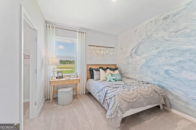 a bedroom with a bed and a painting on the wall