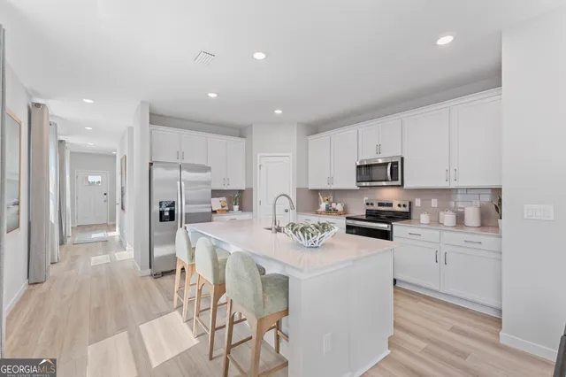 a kitchen with stainless steel appliances a stove sink microwave and cabinets