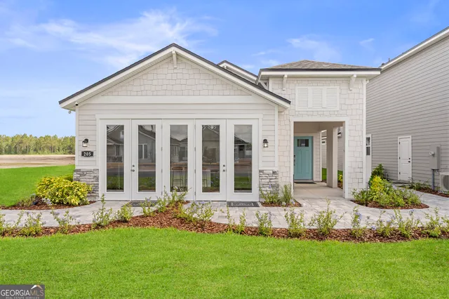 a front view of a house with a yard