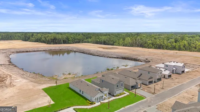 an aerial view of residential houses with outdoor space