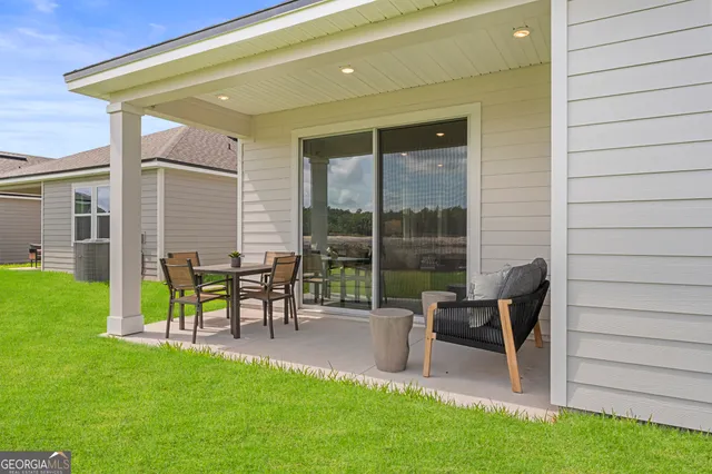 a house view with a seating space and garden