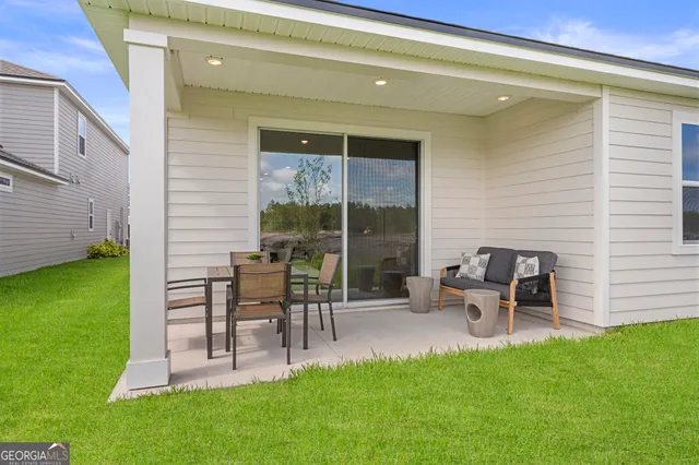 a view of a chair and table in patio of the house