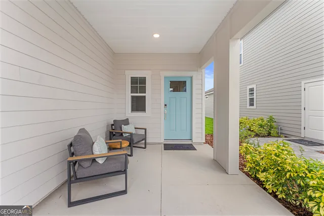 a kitchen with stainless steel appliances granite countertop a stove top oven a sink dishwasher a dining table and chairs with wooden floor