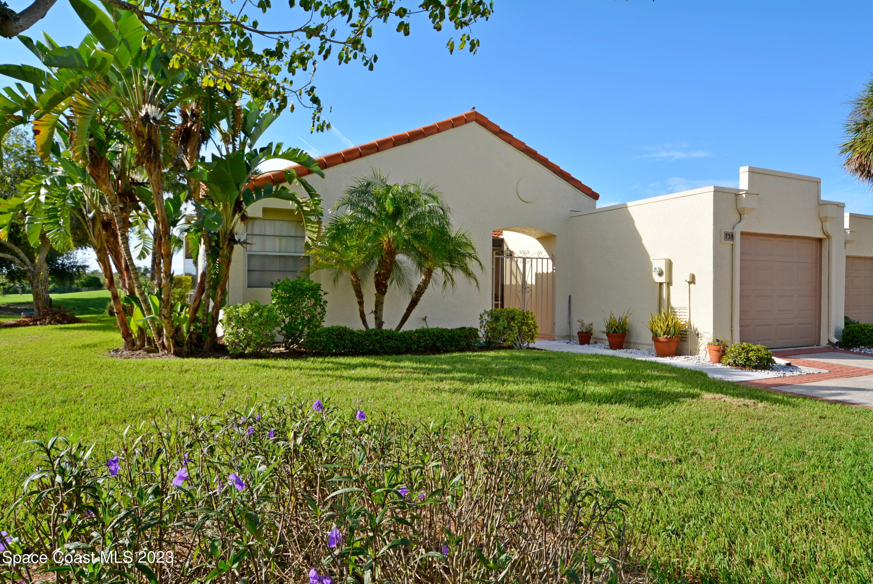 738 Green Valley Lane Melbourne, FL 32940 - Photo 1 of 40 a front view of a house with garden