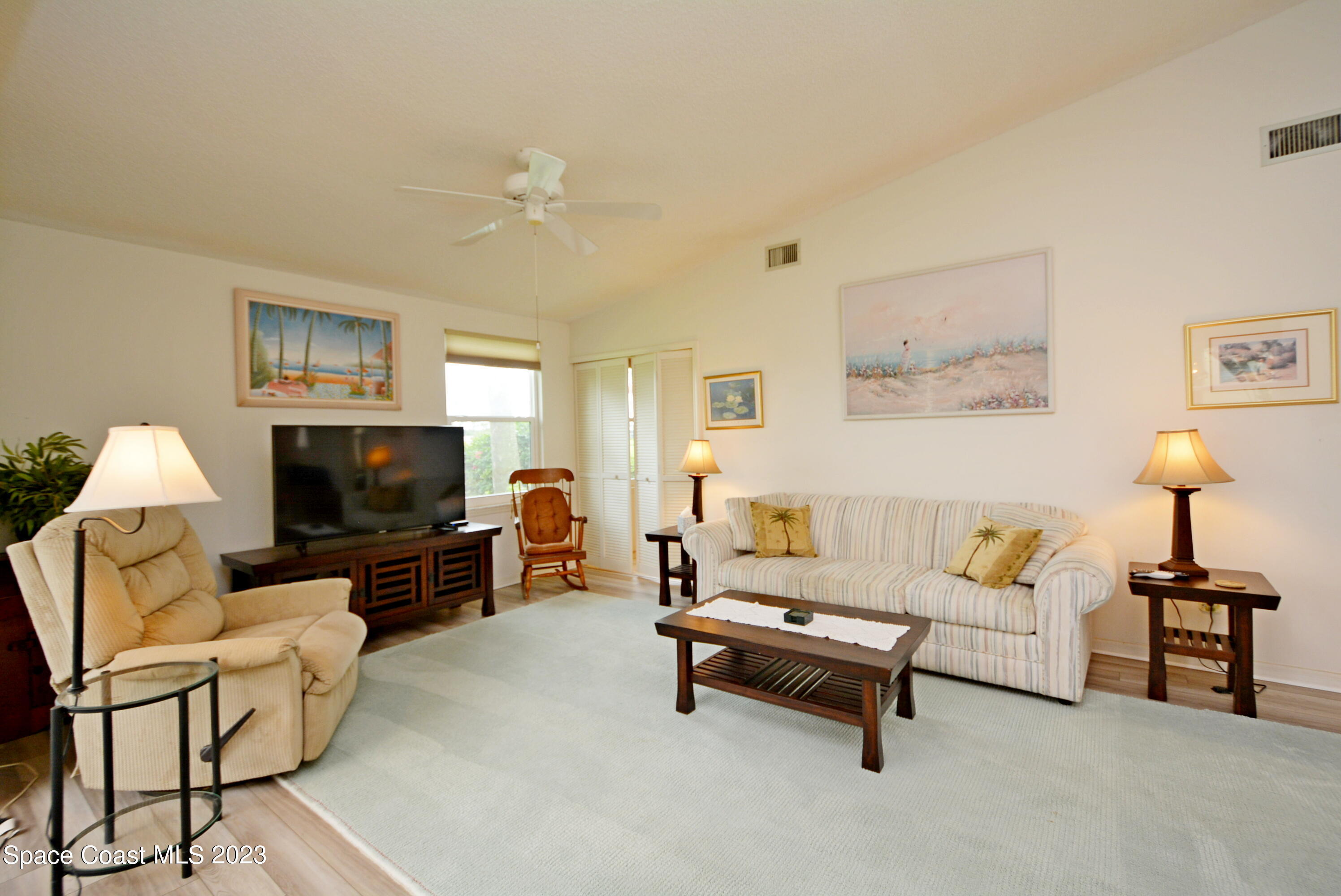 738 Green Valley Lane Melbourne, FL 32940 - Photo 11 of 40 a living room with furniture and a flat screen tv
