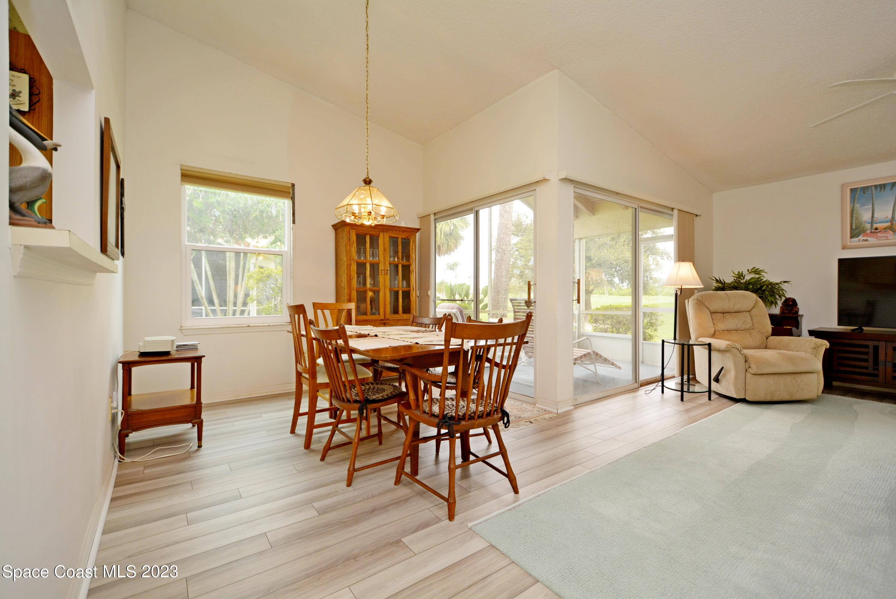 738 Green Valley Lane Melbourne, FL 32940 - Photo 12 of 40 a dining room with furniture and wooden floor