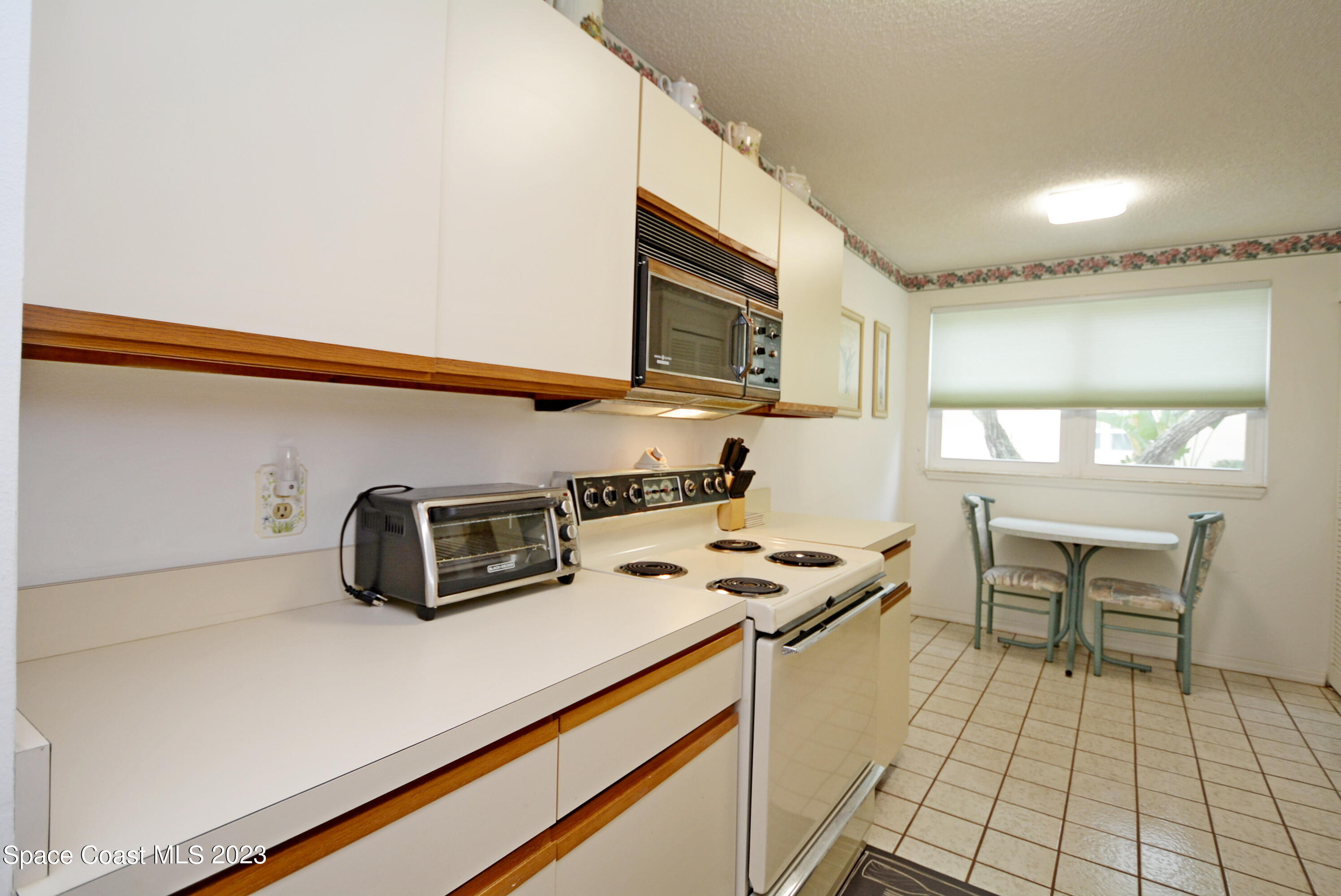 738 Green Valley Lane Melbourne, FL 32940 - Photo 17 of 40 a kitchen with stainless steel appliances a stove a sink and a microwave