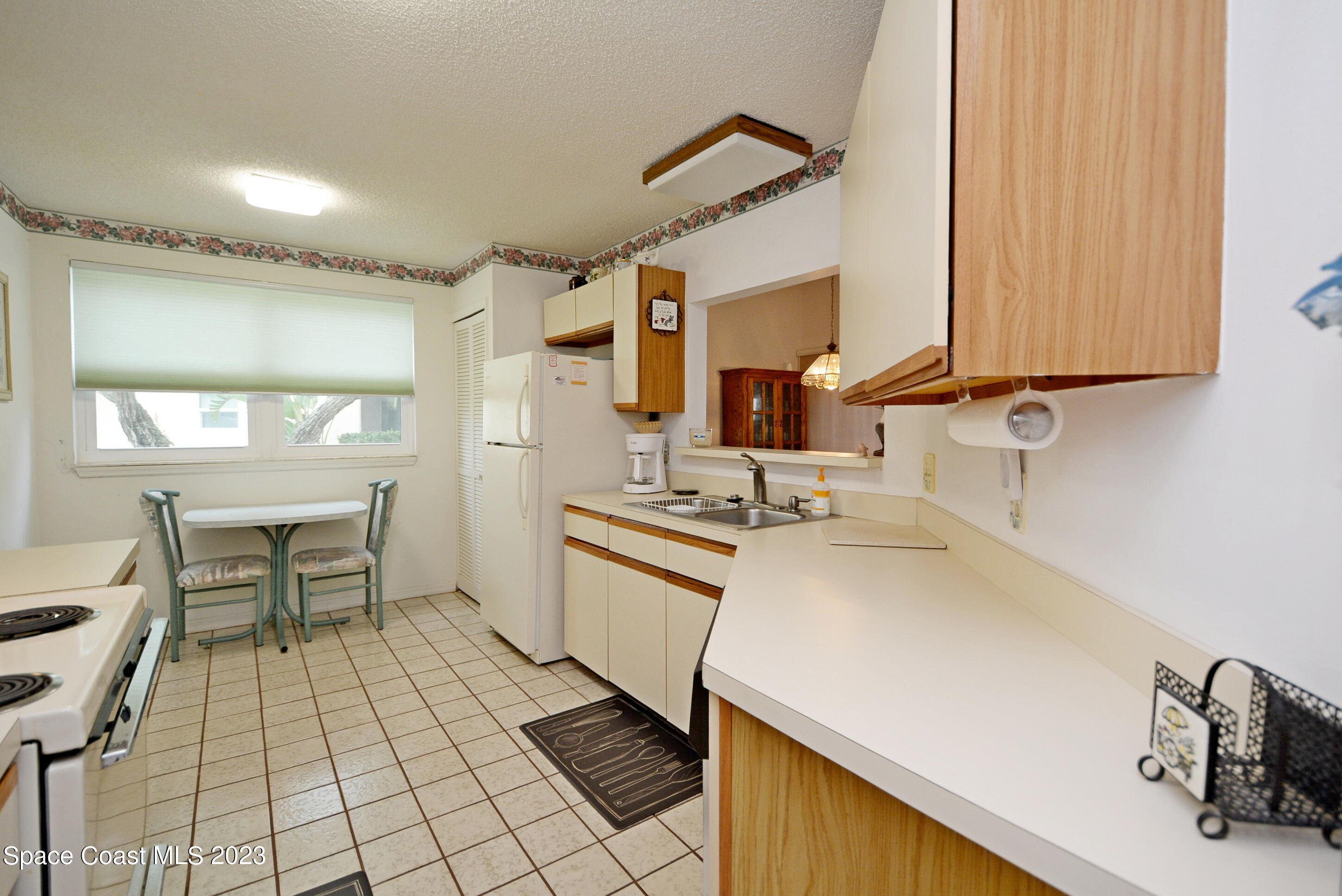 738 Green Valley Lane Melbourne, FL 32940 - Photo 18 of 40 a kitchen with a sink and a stove top oven