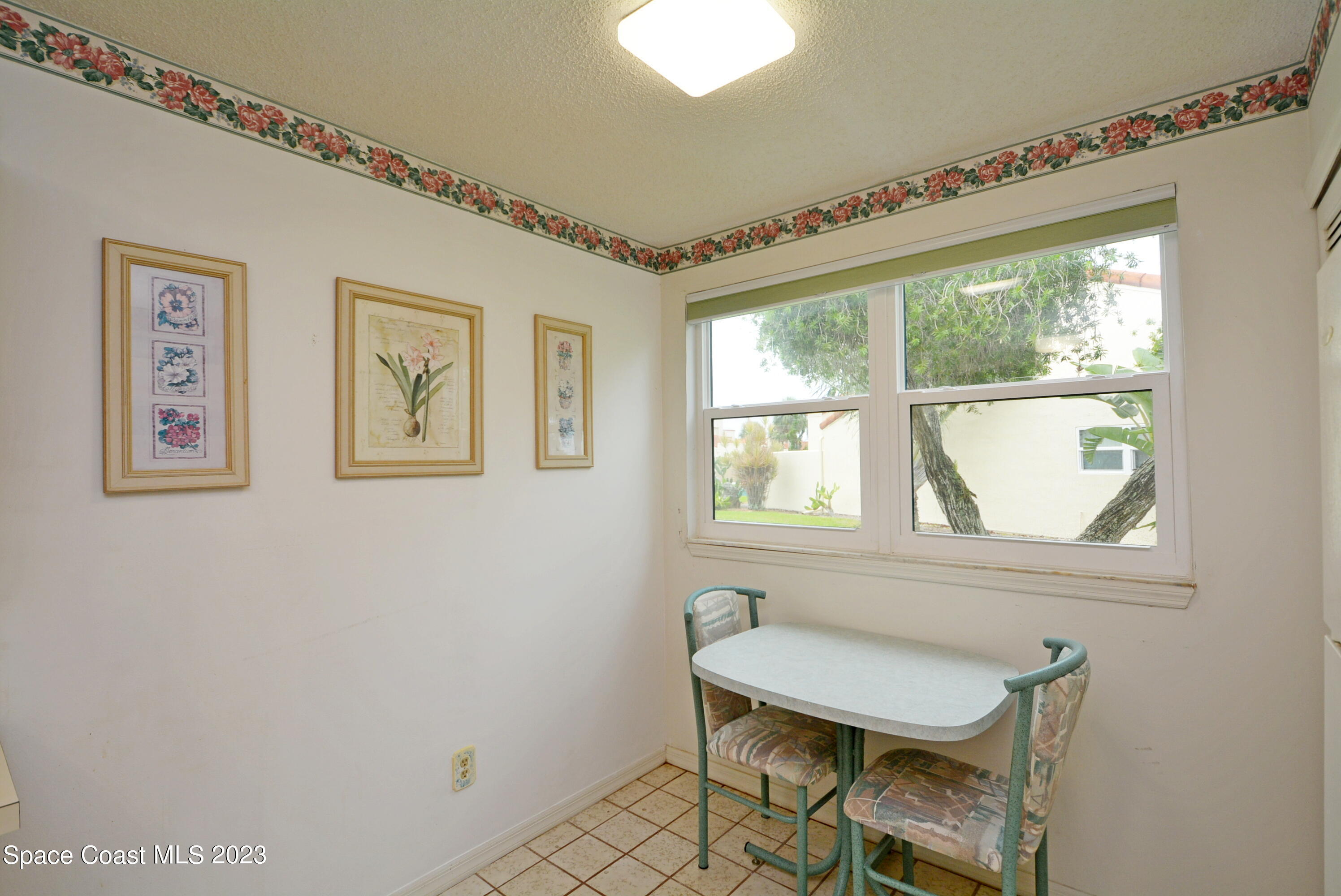 738 Green Valley Lane Melbourne, FL 32940 - Photo 19 of 40 a view of a workspace with furniture and a window