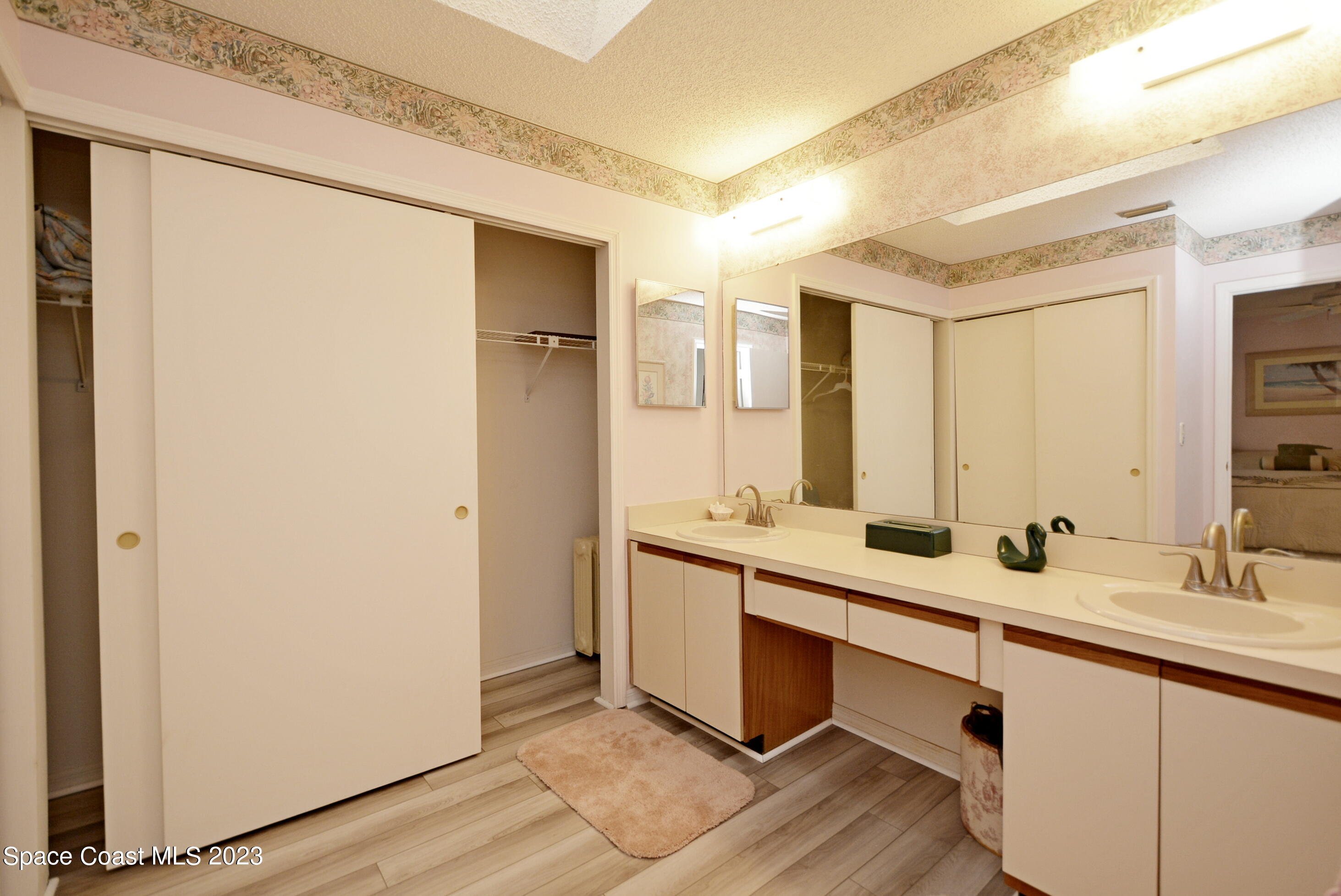 738 Green Valley Lane Melbourne, FL 32940 - Photo 23 of 40 a bathroom with a double vanity sink and a mirror