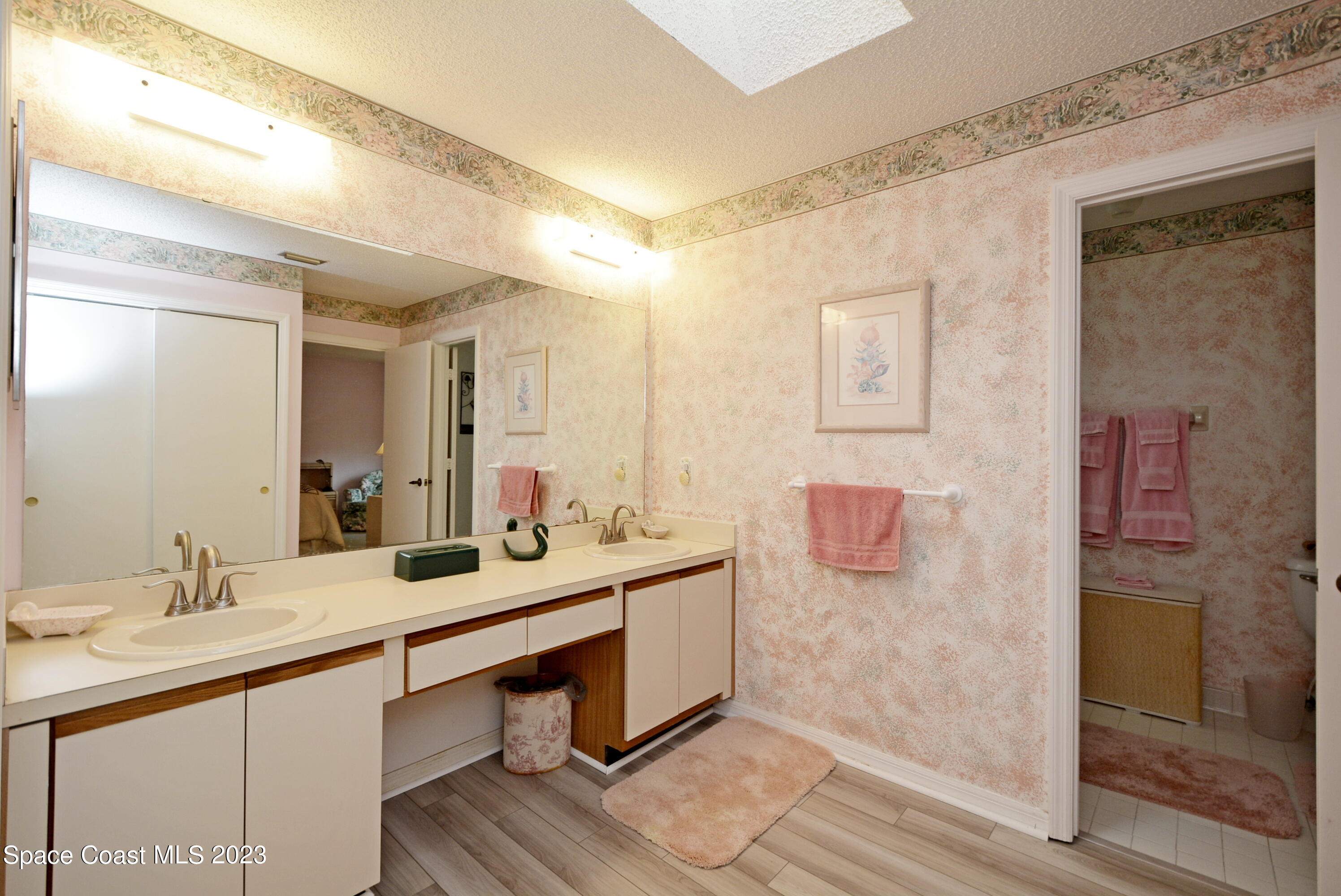 738 Green Valley Lane Melbourne, FL 32940 - Photo 24 of 40 a bathroom with a sink and a mirror