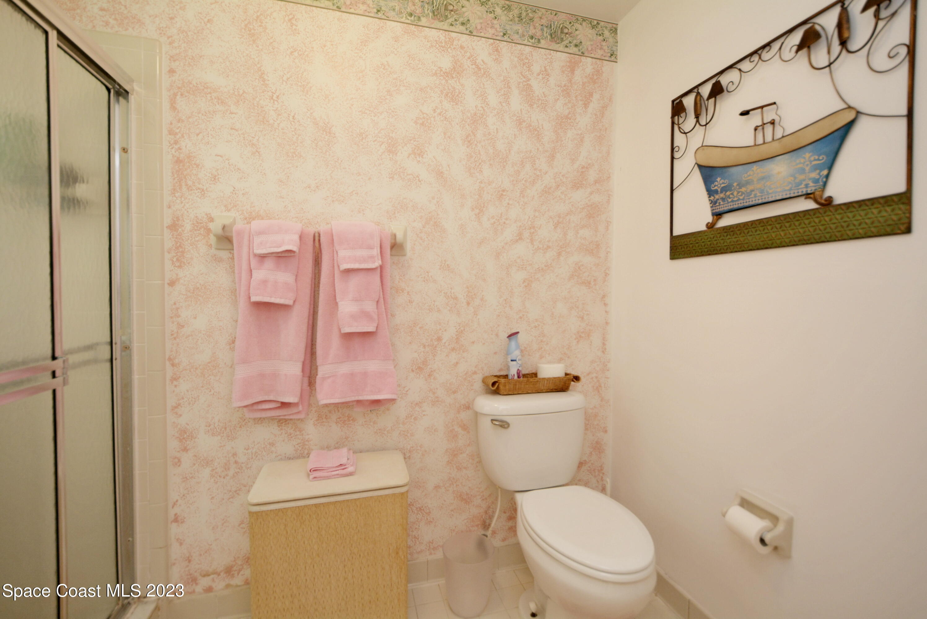 738 Green Valley Lane Melbourne, FL 32940 - Photo 26 of 40 a white toilet sitting next to a bathroom sink